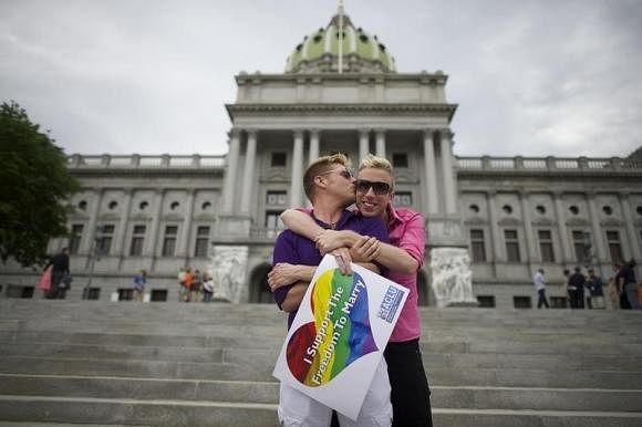 Mike Woods, 28, and Brandon Parsons, 30, embrace on the Pennsylvania State Capital steps following a rally with gay rights supporters after a ruling struck down a ban on same sex marriage in Harrisburg, Pennsylvania, May 20, 2014. Reuters