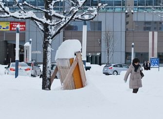 Northern Japan was in the grip of a blizzard as a woman walks on a snow-covered road in Obihiro in Japan's northern island of Hokkaido.