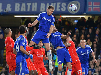 Chelsea's Serbian defender Branislav Ivanovic (C) rises high to head the ball in and score the opening goal during the English League Cup match against Liverpool. AFP