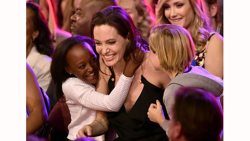 Actress Angelina Jolie hugs her daughters