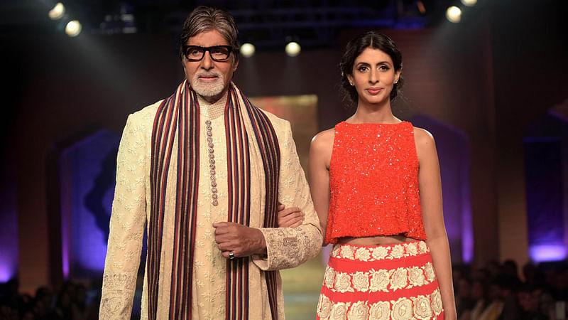 Indian Bollywood actor Amitabh Bachchan (L) and his daughter Shweta Nanda model creations by designer Manish Malhotra during a charity fashion show in Mumbai on late on 4 April, 2015.