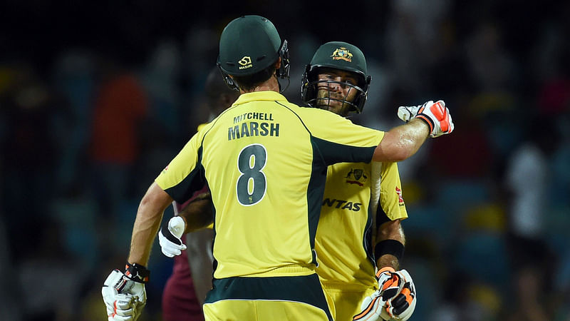 Australian cricketer Mitchell Marsh (#8) and his teammate Glenn Maxwell celebrate their vicoty during the 8th One Day International match of the Tri-nation Series between Australia and West Indies at the Kensington Oval stadium in Bridgetown. Photo: AFP