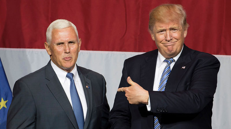 US Republican presidential candidate Donald Trump (R) and Indiana governor Mike Pence (L) taking the stage during a campaign rally at Grant Park Event Center in Westfield, Indiana