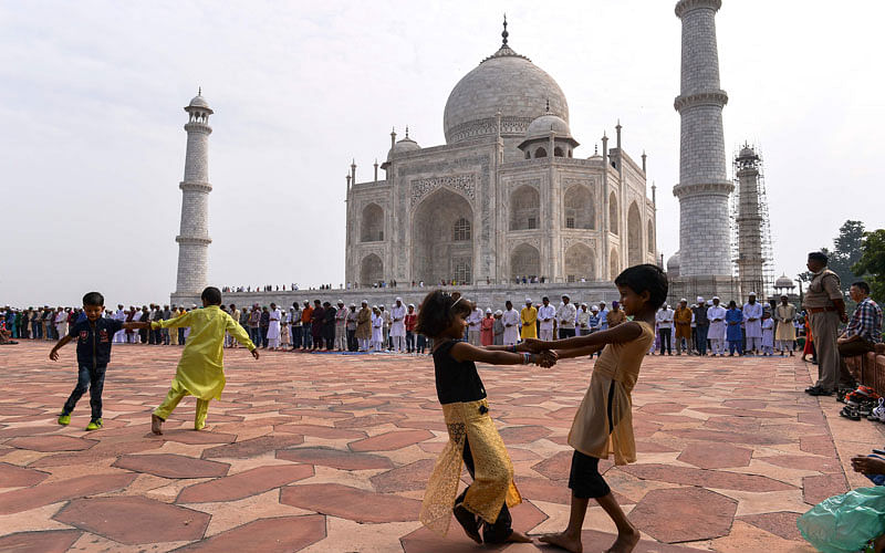 Indian Muslim children play in the courtyard during the Eid al-Adha festival at the mosque inside the Taj Mahal in Agra on Tuesday.