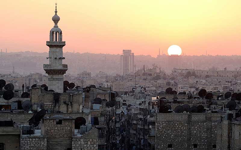 The sun sets over Aleppo as seen from rebel-held part of the city, Syria.