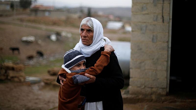 Ayman, a boy from a minority Yazidi community, who was sold by Islamic State militants to a Muslim couple in Mosul, hugs his grandmother after he was returned to his Yazidi family, in Duhok, Iraq, 31 January, 2017.