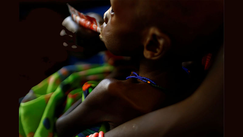 A mother feeds her child with a peanut-based paste for treatment of severe acute malnutrition in a UNICEF supported hospital in the capital Juba, South Sudan on 25 January, 2017