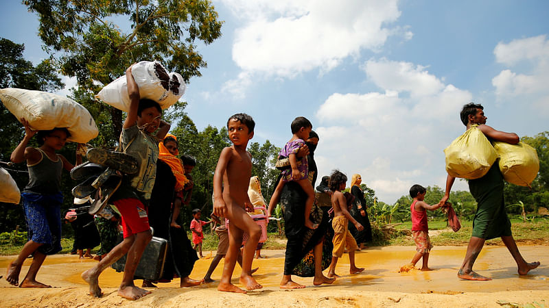 Rohingya people walk towards the makeshift shelter near the Bangladesh-Myanmar border, after being restricted by the members of Border Guards Bangladesh (BGB), to further enter into the Bangladesh side, in Cox’s Bazar, Bangladesh August 28, 2017.