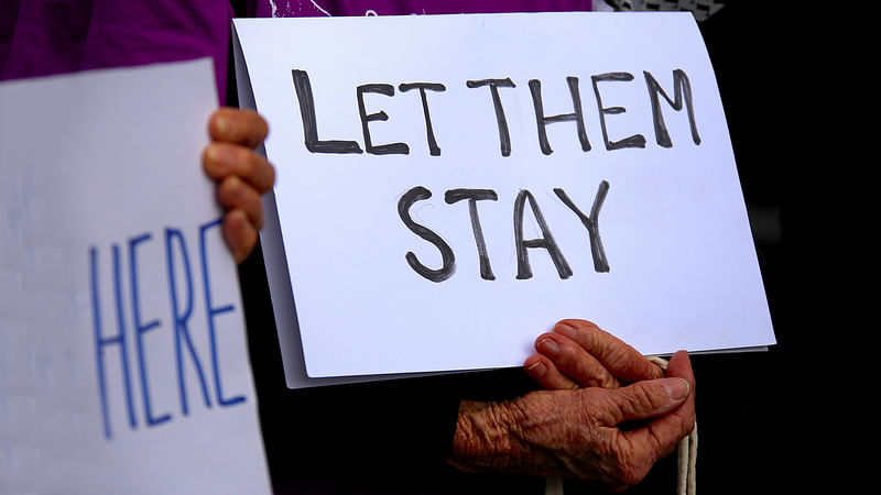 Refugee advocates hold signs as they protest against the detention of asylum seekers being held at Australian-run offshore detention centers located on Papua New Guinea`s Manus Island, and the South-Pacific island of Nauru, in central Sydney. Reuters