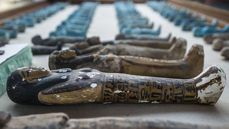 A picture taken on September 9,2017 shows small funerary statues carved in wood, clay and limestone recovered at the site of a newly-uncovered ancient tomb for a goldsmith dedicated to the ancient Egyptian god Amun, in the Draa Abul Naga necropolis on the west bank of the ancient city of Luxor, which boasts ancient Egyptian temples and burial grounds.