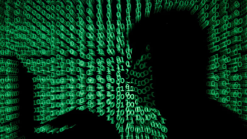 A man holds a laptop computer as cyber code is projected on him in this illustration picture taken on 13 May 2017