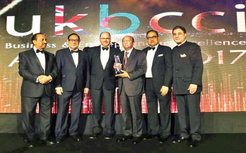 Latifur Rahman holding Pepsico's 'Global Bottler of the Year' award