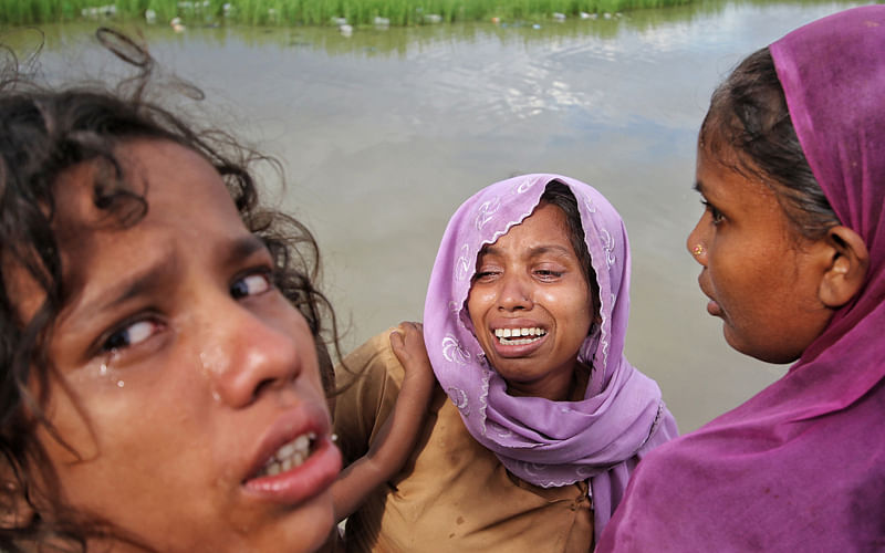 Three Rohingya women cry after their mother went missing at Palangkhali area of Ukhia, Cox’s Bazaar.