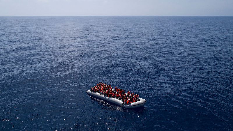 Refugees and migrants are rescued by members of the Spanish NGO Proactiva Open Arms, after leaving Libya trying to reach European soil aboard an overcrowded rubber boat, north of Libyan coast on Sunday, 6 May 2018