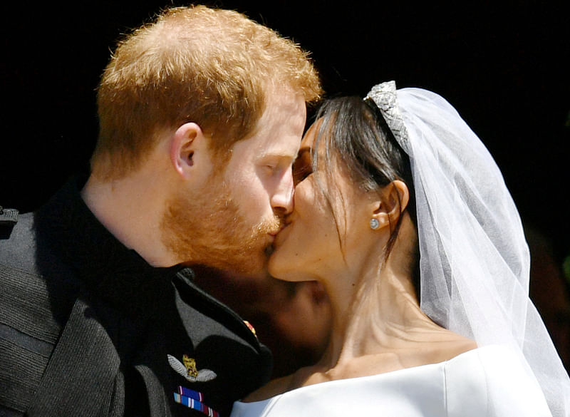 Prince Harry and Meghan Markle kiss on the steps of St George`s Chapel in Windsor Castle after their wedding in Windsor, Britain, 19 May, 2018.
