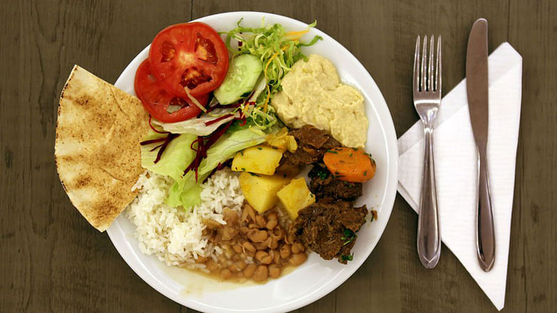 A meal of bread, salad, humus, meat, potatoes, rice and beans is seen in Sao Paulo, Brazil