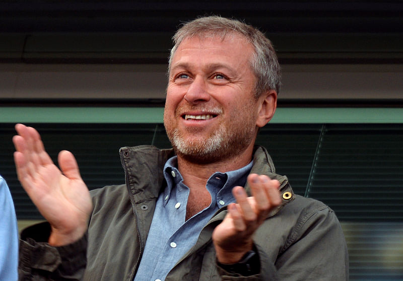 Chelsea's former owner Roman Abramovich applauds the players from the stands of Stamford Bridge in London.