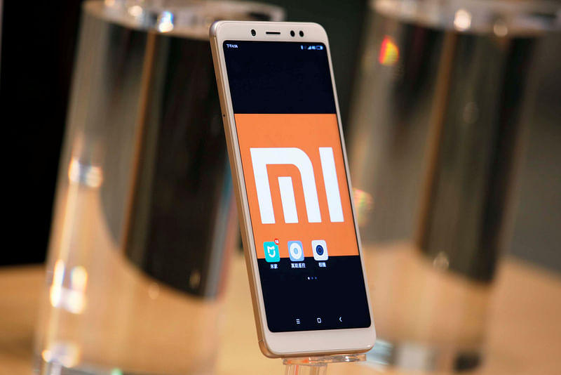 A company logo of Xiaomi is displayed on its smartphone in Hong Kong.