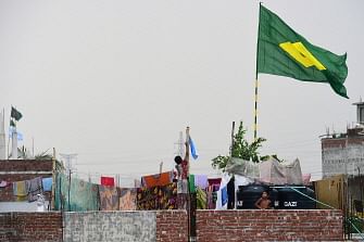 This photograph taken on 6 June 2018 shows a child (C) hoisting the national flag of Argentina on the outskirts of Dhaka