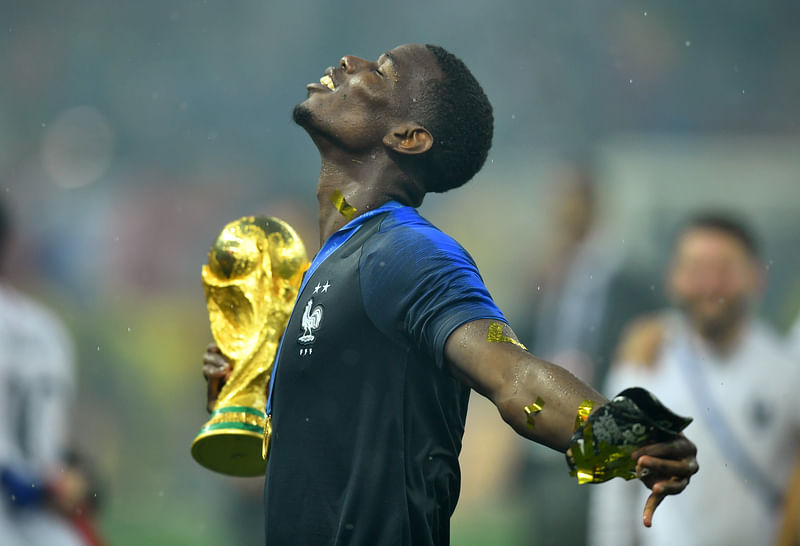 France's Paul Pogba holds the trophy as he celebrates winning the World Cup