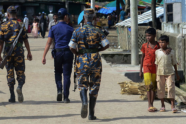 This photo taken on 18 July, 2018 shows police patrolling in a Rohingya refugee camp in Teknaf.