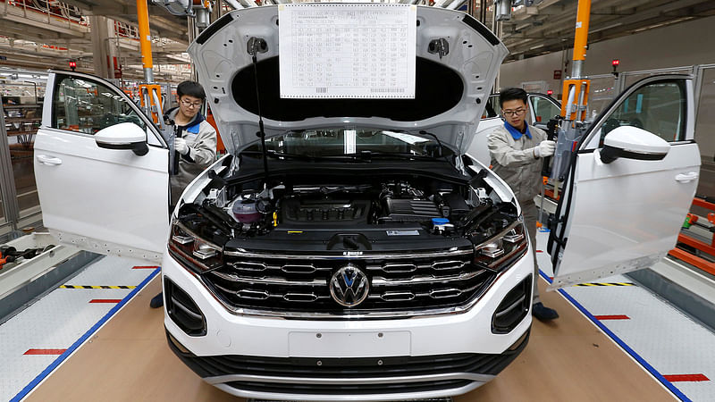 Workers are seen at the production line for Volkswagen Tayron cars at the FAW-Volkswagen Tianjin Plant in Tianjin, China on 12 December 2018