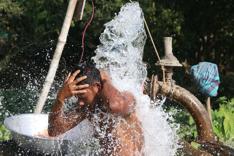 A farmer bathing in deep tubewell water in Brahmanpara, Cumilla