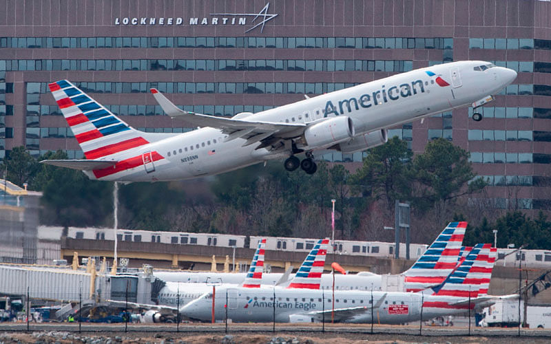 In this file photo taken on 11 March 2019 a Boeing 737 flown by American Airlines passes by the Lockheed Martin building as it takes off from Ronald Reagan Washington National Airport in Arlington, Virginia.