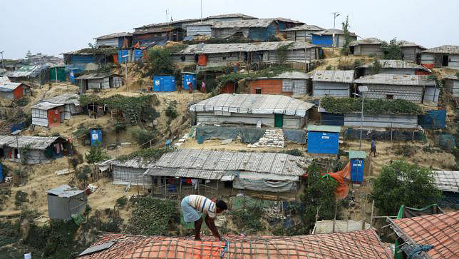 A Rohingya refugee repairs the roof of his shelter at the Balukhali refugee camp in Cox’s Bazar, Bangladesh, on 5 March 2019.