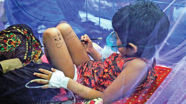 A  child is seen painting on the body while undergoing treatment for dengue at a Dhaka hospital.