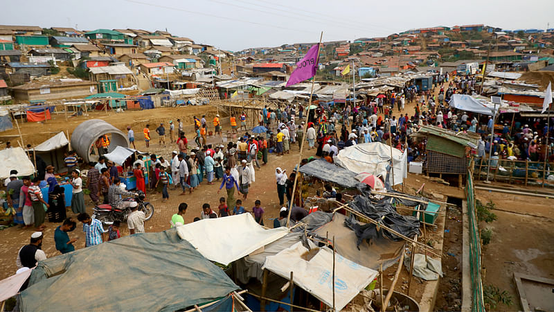 Rohingya refugees gather at a market inside a refugee camp in Cox`s Bazar.