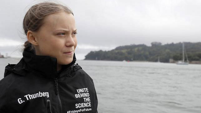 Swedish climate activist Greta Thunberg walks along the quayside to board an electric powered rib, before travelling to board the Malizia II IMOCA class sailing yacht off the coast of Plymouth, southwest England, on 14 August 2019.