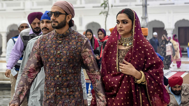 Bollywood actress Deepika Padukone (R) along with her husband actor Ranveer Singh arrive to pay respect, celebrating their one-year wedding anniversary, at the Golden Temple in Amritsar on 15 November 2019. Photo: AFP