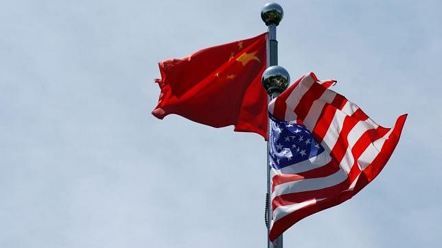 Chinese and US flags flutter near The Bund, before US trade delegation meet their Chinese counterparts for talks in Shanghai, China on 30 July.