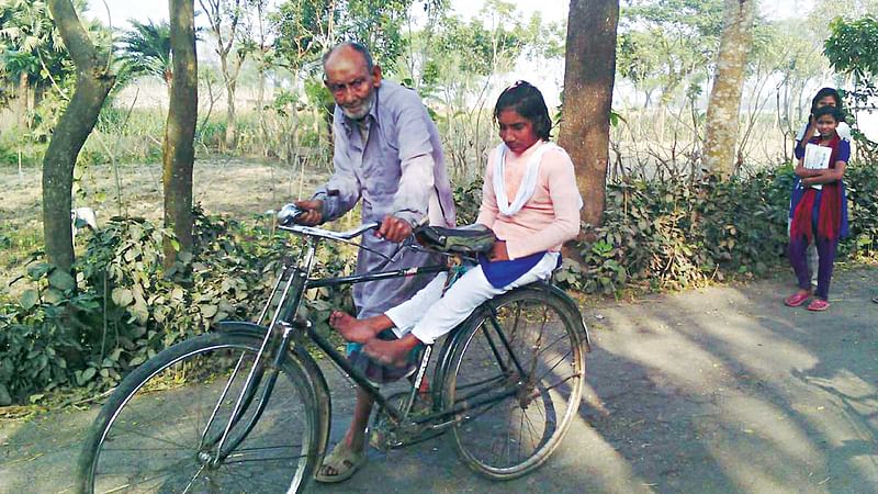 নানার সাইকেলে চড়ে স্কুলে যাচ্ছে প্রীতিলতা সাহা l ছবি: প্রথম আলো