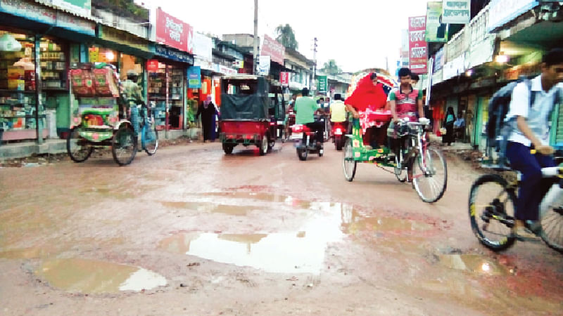 দোহার পৌরসভার জয়পাড়া কলেজ–থানার মোড় সড়ক খানাখন্দে ভরা। জয়পাড়া বাসস্ট্যান্ড এলাকা থেকে সম্প্রতি তোলা ছবি l প্রথম আলো