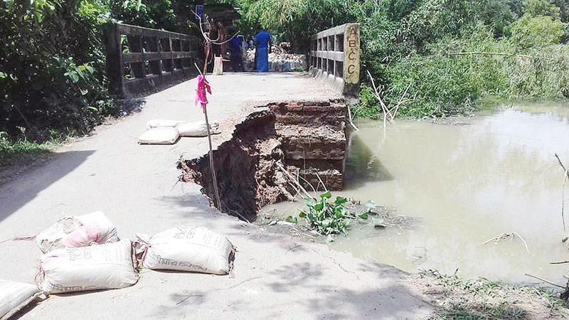 রাউজানের নোয়াপাড়া মুহাম্মদ শাহ সড়কে অবস্থিত এই সেতুর দুই পাশেই সড়ক ভেঙে গর্ত তৈরি হয়েছে। এতে বন্ধ হয়ে গেছে যানবাহন চলাচল। ছবিটি গতকাল দুপুরে তোলা l প্রথম আলো