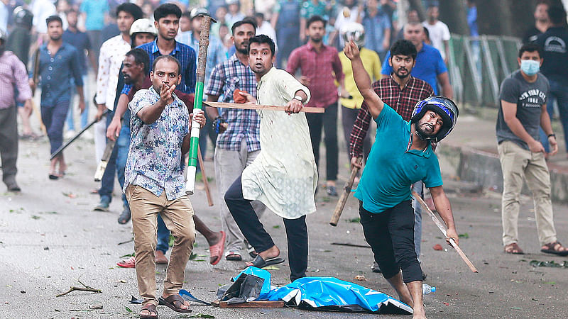 নিরাপদ সড়কের দাবিতে আন্দোলনরত শিক্ষার্থীদের ওপর লাঠিসোঁটা নিয়ে হামলা চালান এই যুবকেরা। গতকাল বিকেলে ধানমন্ডির জিগাতলায়।  ছবি: প্রথম আলো