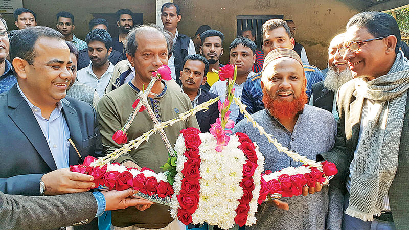 শিবপুরের চক্রধা গ্রামে গতকাল দুপুরে আবদুল মান্নান ভূঁইয়া পরিষদের নেতাদের নৌকার ফুল দিয়ে বরণ করে নেওয়া হয়।  ছবি: প্রথম আলো