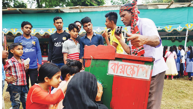 বায়োস্কোপ দেখছে শিশুরা। সম্প্রতি গাজীপুরের হাজী জমির ‍উদ্দিন বিদ্যালয়ের মাঠে।  ছবি: প্রথম আলো