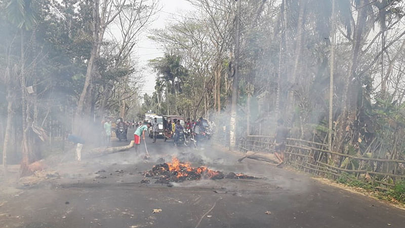 পিরোজপুরে দুদকের মামলায় সাবেক সাংসদ আউয়াল ও তাঁর স্ত্রীকে কারাগারে পাঠানোর প্রতিবাদে গাছের গুঁড়ি ফেলে ও আগুন জ্বালিয়ে সড়ক অবরোধ করেন তাঁর অনুসারীরা। আজ মঙ্গলবার দুপুরে পিরোজপুর সদরের পাড়েরহাট সড়কে। ছবি: এ কে এম ফয়সাল