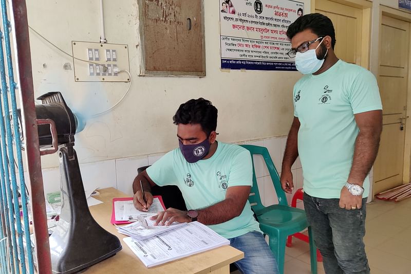Two volunteers are working at the entrance of Corona Ward of Kushtia General Hospital. June 3 morning