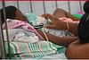 A sick child is lying in a hospital bed in Colombo