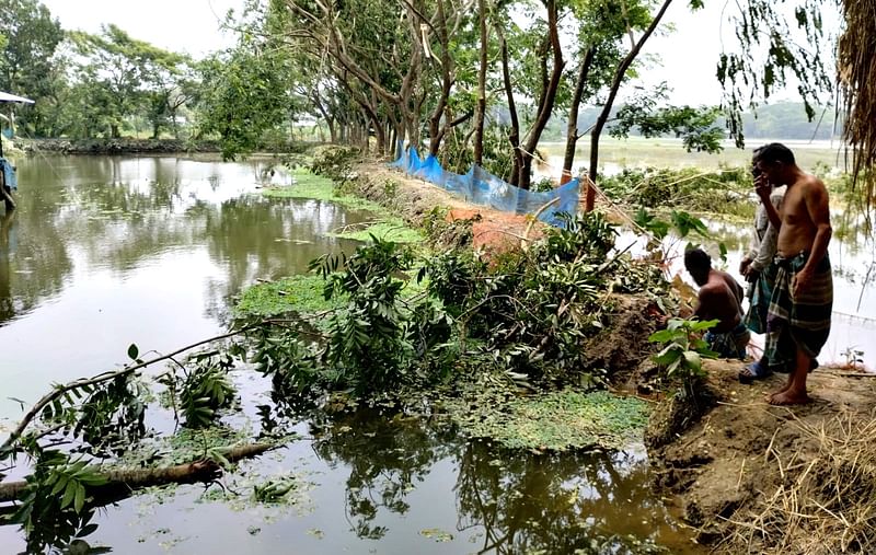 ঘূর্ণিঝড় রিমালের প্রভাবে জলোচ্ছ্বাস ও প্রবল বর্ষণে ঘেরের সব মাছ ভেসে গেছে। দিশেহারা ঘেরমালিক দুলাল হাওলাদার। গত বুধবার দুপুরে বরিশালের বাকেরগঞ্জ উপজেলার চর বোয়ালিয়া গ্রামেছবি: প্রথম আলো