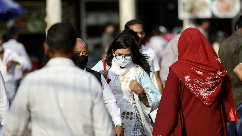 People wear masks as a protective measure after the first reported case of coronavirus in Dhaka, Bangladesh, 9 March 2020. Reuters