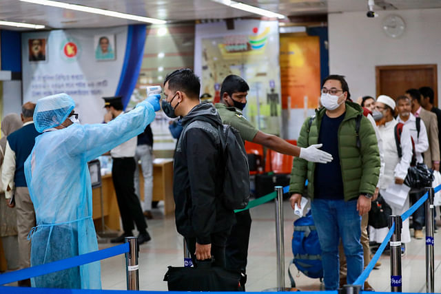 Passengers are checked with thermal scanner at the Hazrat Shahjalal International Airport in Dhaka, 11 March  2020.