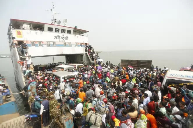 People board a ferry at Shimulia Ghat in Munshiganj on 5 April 2020 after they failed to enter Dhaka amid a lock down due to coronavirus outbreak. 