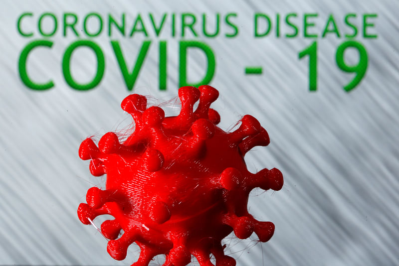 A 3D-printed coronavirus model is seen in front of the words coronavirus disease (Covid-19) on display in this illustration taken 25 March. 