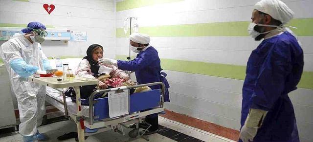 Health workers treat a patient