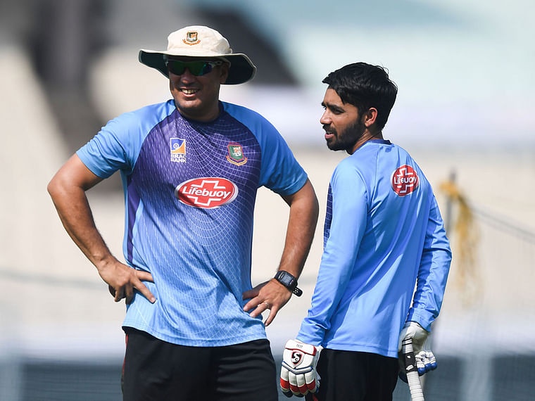 Bangladesh`s cricket team captain Mominul Haque (R) confers with head coach Russell Domingo during a practice session at The Eden Gardens cricket stadium in Kolkata on 20 November 2019, ahead of the second Test cricket match between India and Bangladesh